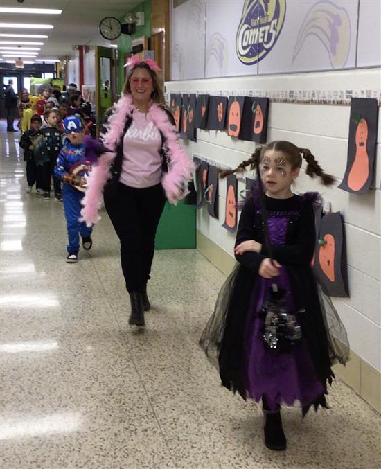 student leading the Halloween Parade