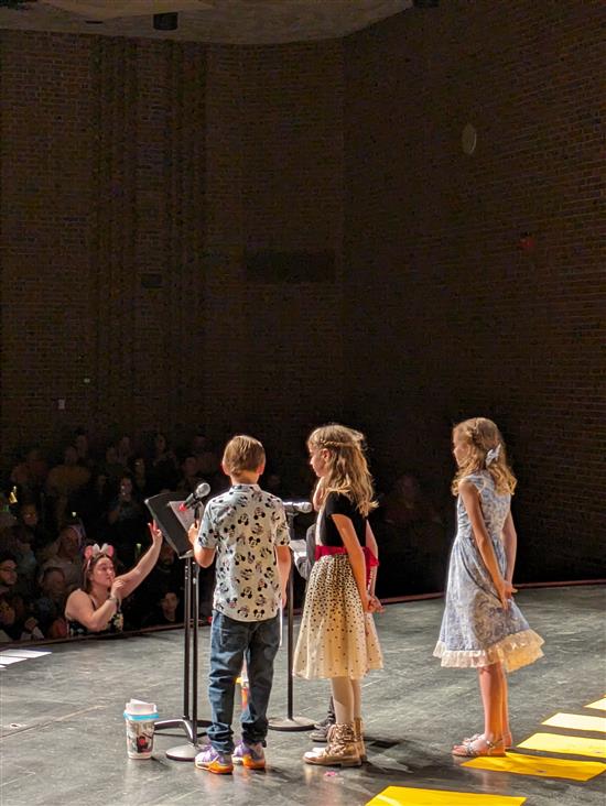 Students on stage singing