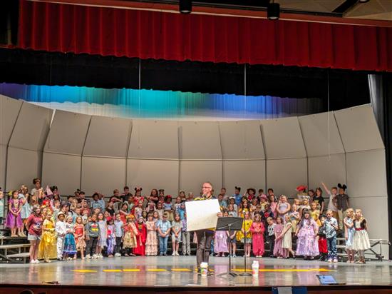 Students on stage singing